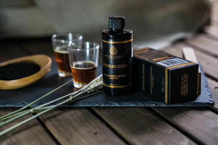two shots of nature's blends finest black seed oil